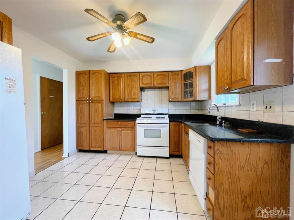 63 Dalton Place Edison, NJ 08817 - Photo 12 of 31 a kitchen with stainless steel appliances granite countertop a stove sink and cabinets