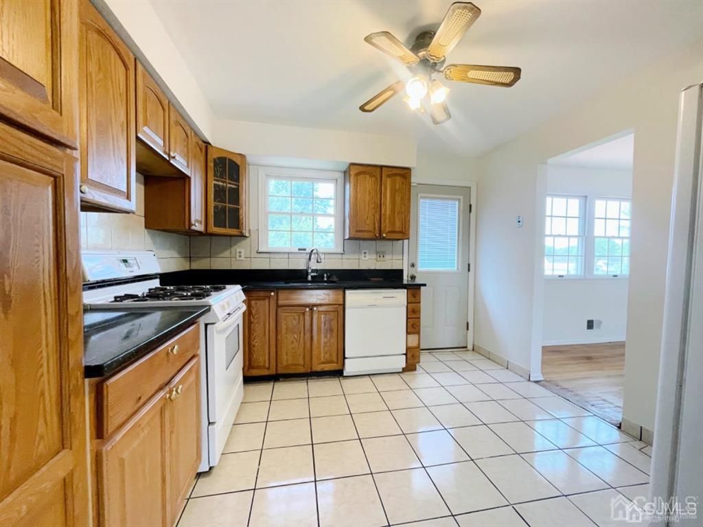 63 Dalton Place Edison, NJ 08817 - Photo 14 of 31 a kitchen with stainless steel appliances granite countertop a stove a sink and a granite counter tops