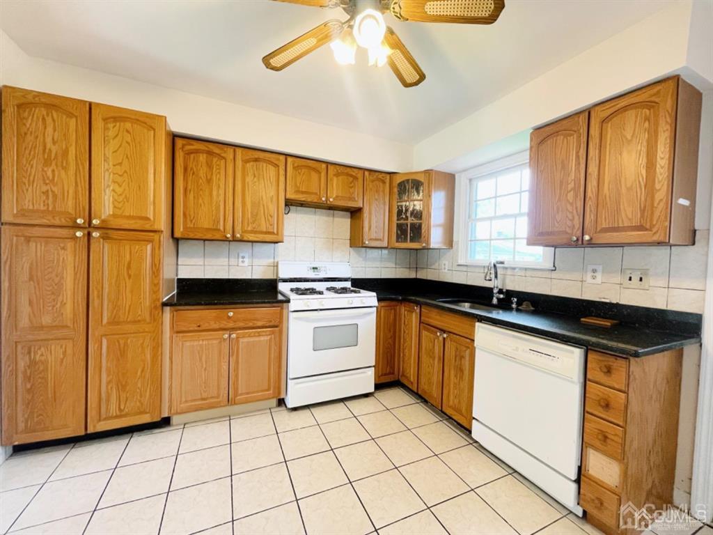 63 Dalton Place Edison, NJ 08817 - Photo 15 of 31 a kitchen with stainless steel appliances granite countertop a sink and cabinets