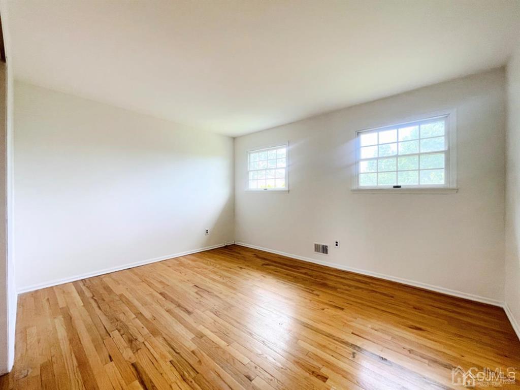 63 Dalton Place Edison, NJ 08817 - Photo 17 of 31 an empty room with wooden floor and windows