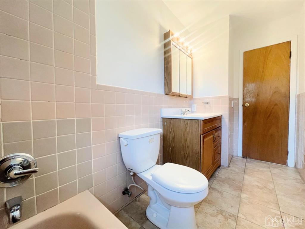 63 Dalton Place Edison, NJ 08817 - Photo 21 of 31 a bathroom with a sink a toilet and mirror