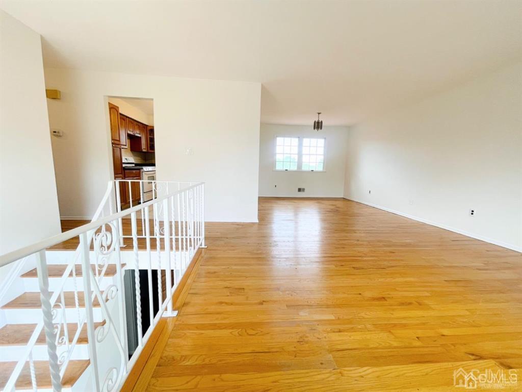 63 Dalton Place Edison, NJ 08817 - Photo 7 of 31 a view of an empty room with stairs and a window