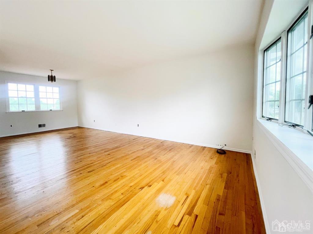 63 Dalton Place Edison, NJ 08817 - Photo 8 of 31 an empty room with wooden floor and windows