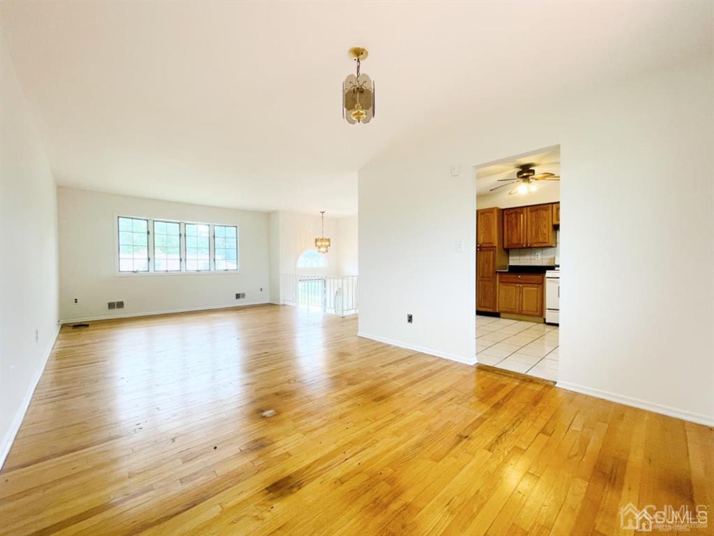 63 Dalton Place Edison, NJ 08817 - Photo 10 of 31 a view of empty room with wooden floor and fan