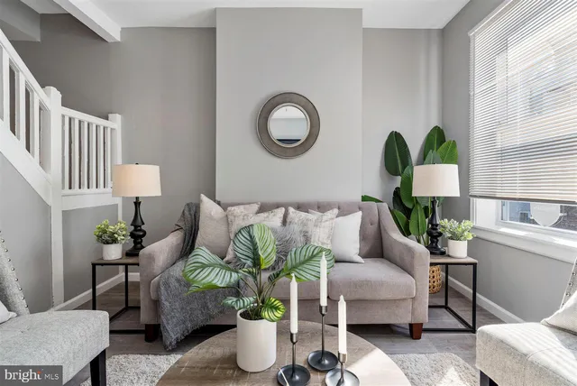 a living room with furniture flowerpot and window