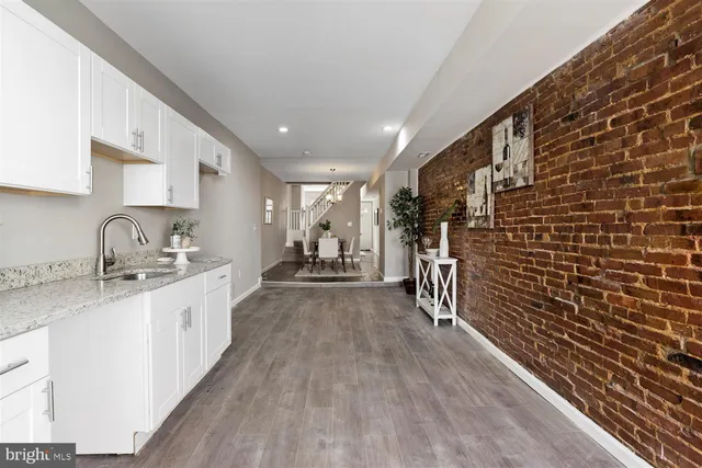 a kitchen with sink cabinets and wooden floor