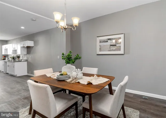 a dining room with furniture and wooden floor