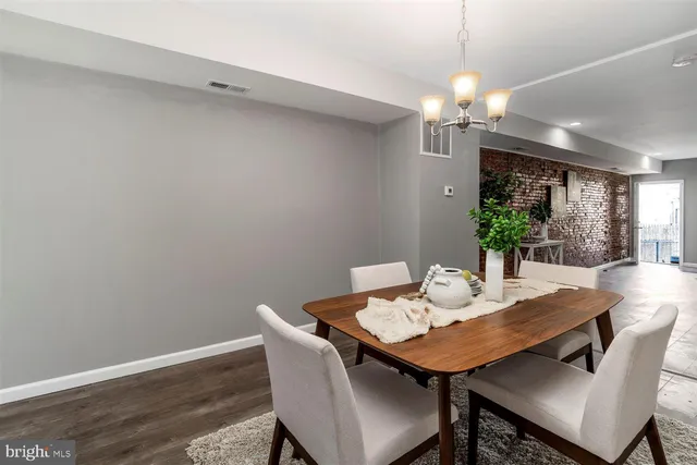 a view of a dining room with a table and chairs