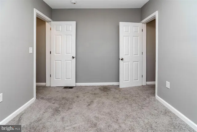 an empty room with closet area