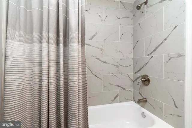 a bathroom with a bathtub and shower