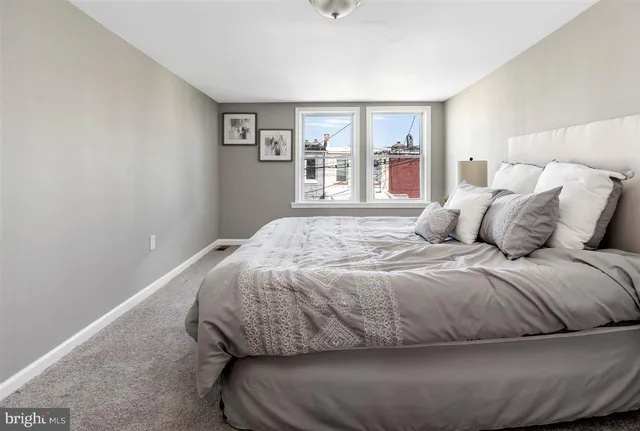 a bedroom with a large bed and a window