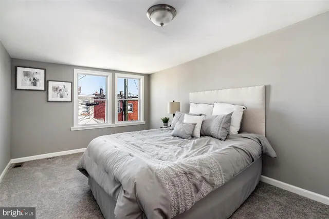 a bedroom with a large bed and a large window