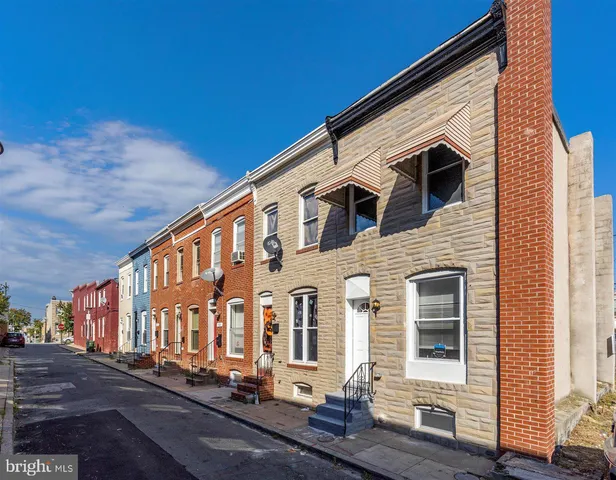 a front view of a house with many windows