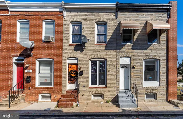 a front view of a house with large windows