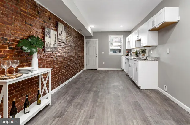 a kitchen with stainless steel appliances granite countertop a stove and a wooden floors