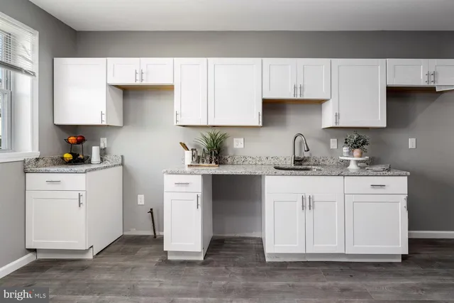 a kitchen with stainless steel appliances white cabinets and a sink