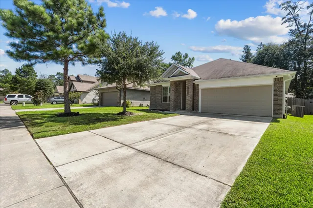 a front view of a house with a yard and trees