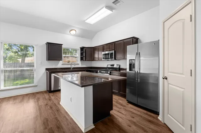 a kitchen with a refrigerator sink and microwave