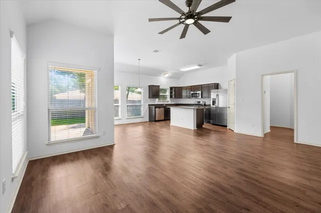 a view of a kitchen with a sink and a window