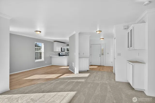 a view of empty room with wooden floor and windows