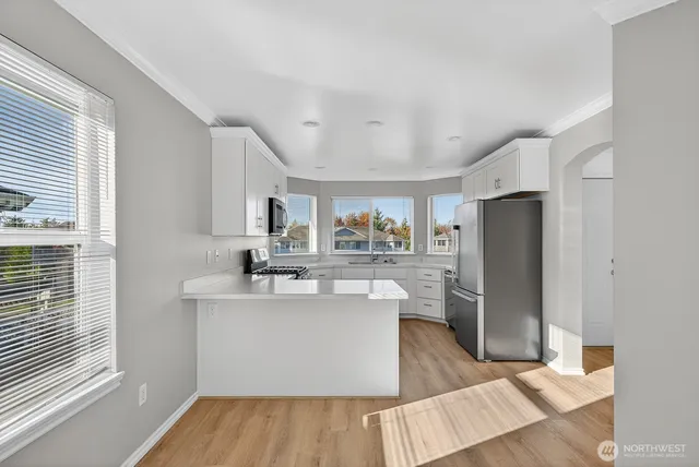 a kitchen with stainless steel appliances a sink stove and refrigerator