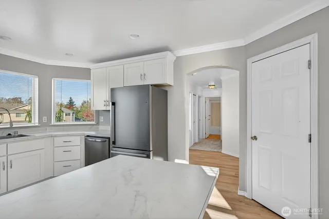 a kitchen with a refrigerator and a sink