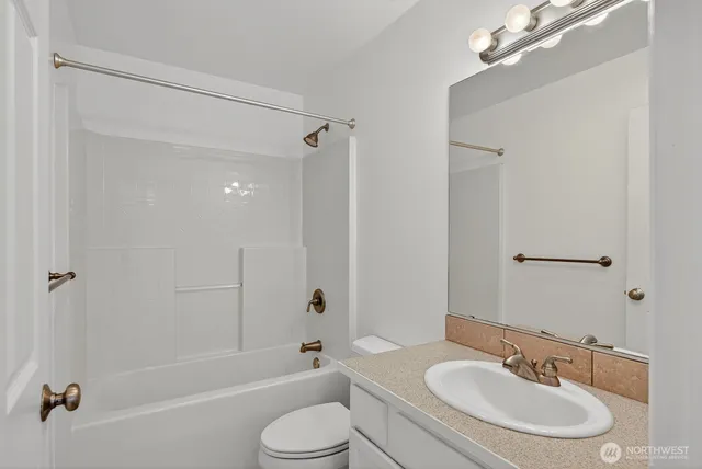 a bathroom with a sink toilet a shower and bathtub