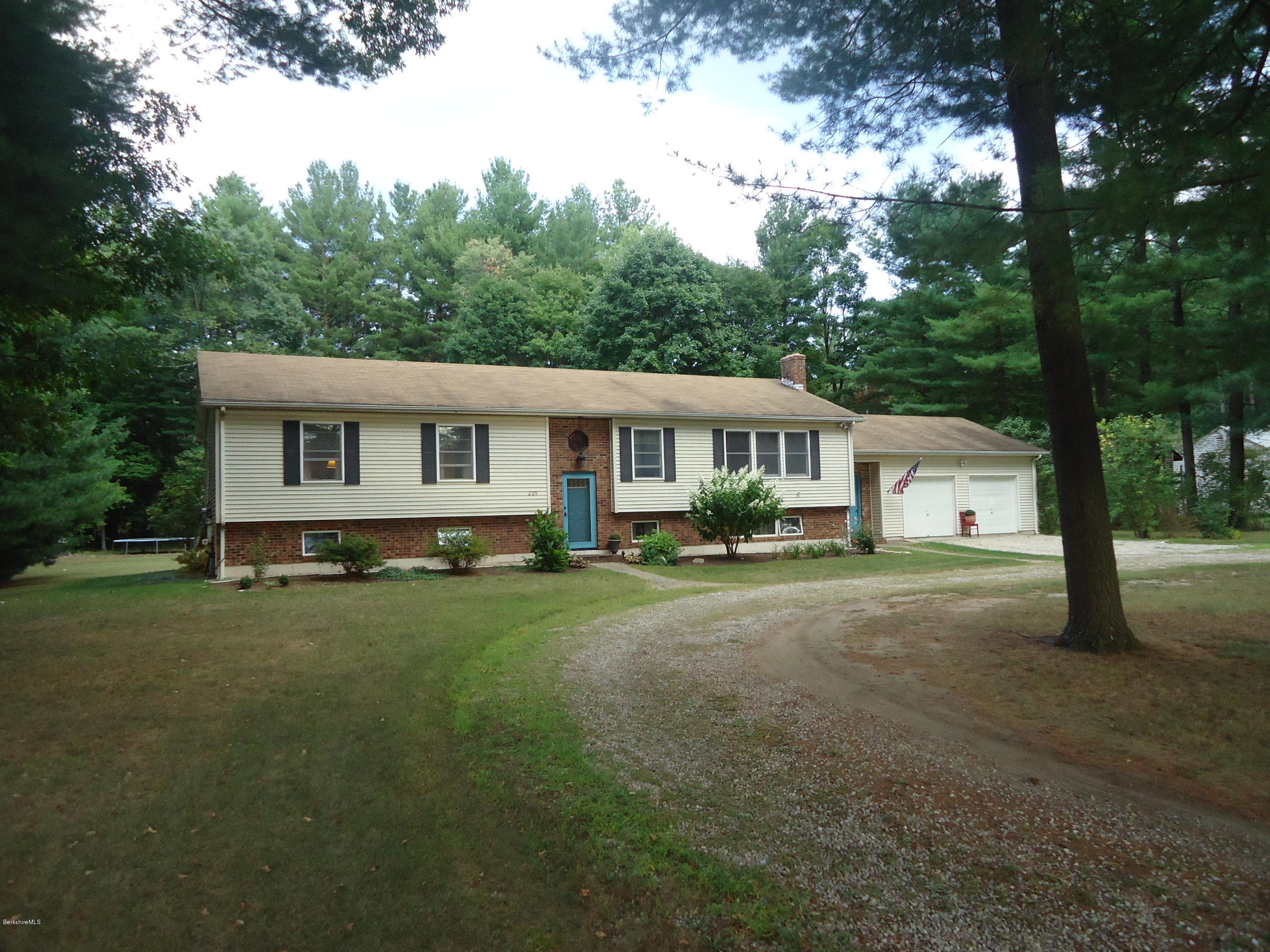 209 Polikoff Road Sheffield, MA 01222 - Photo 1 of 16 a front view of a house with a yard and trees