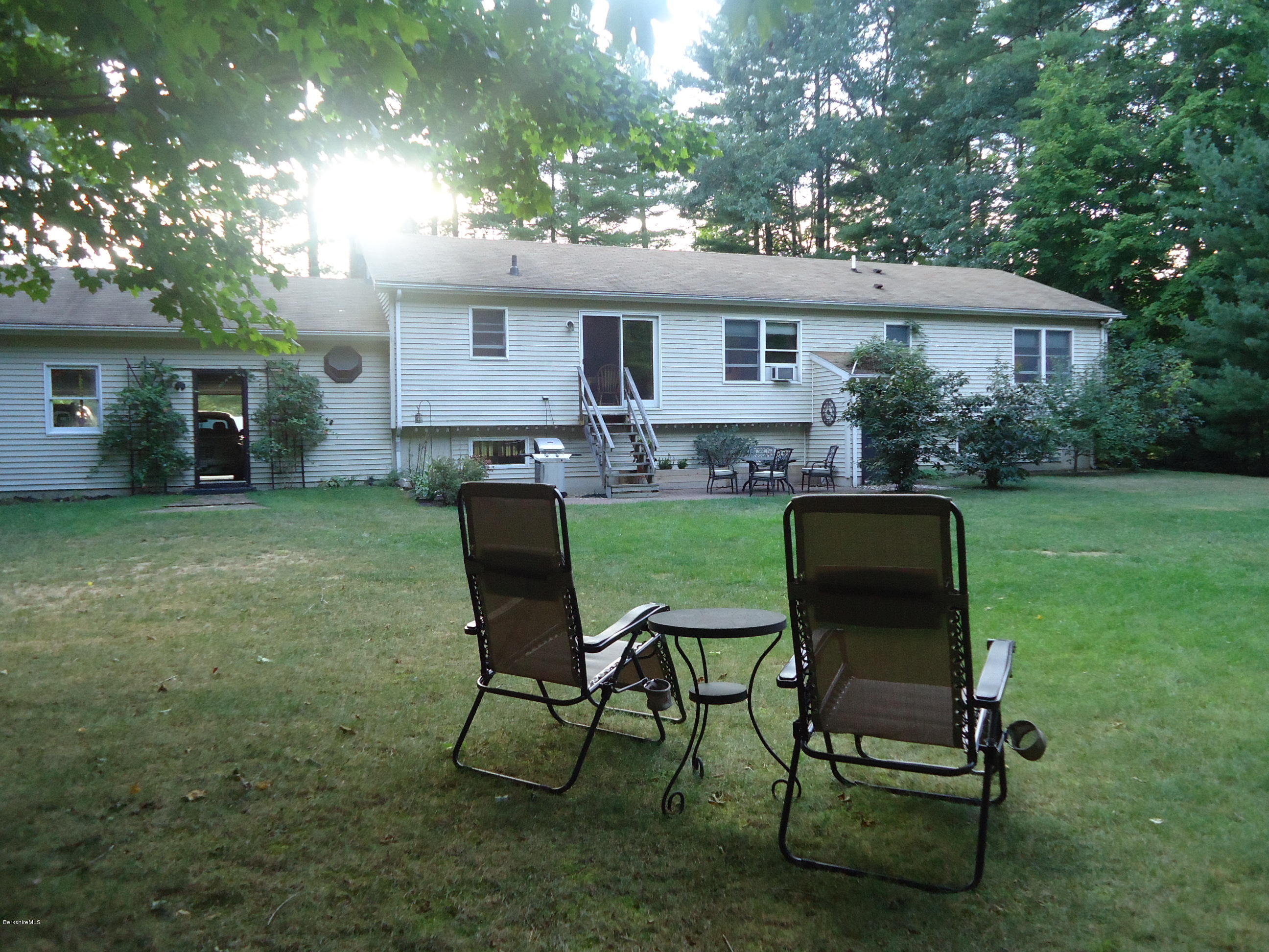 209 Polikoff Road Sheffield, MA 01222 - Photo 3 of 16 a view of a house with a yard chairs and table in patio