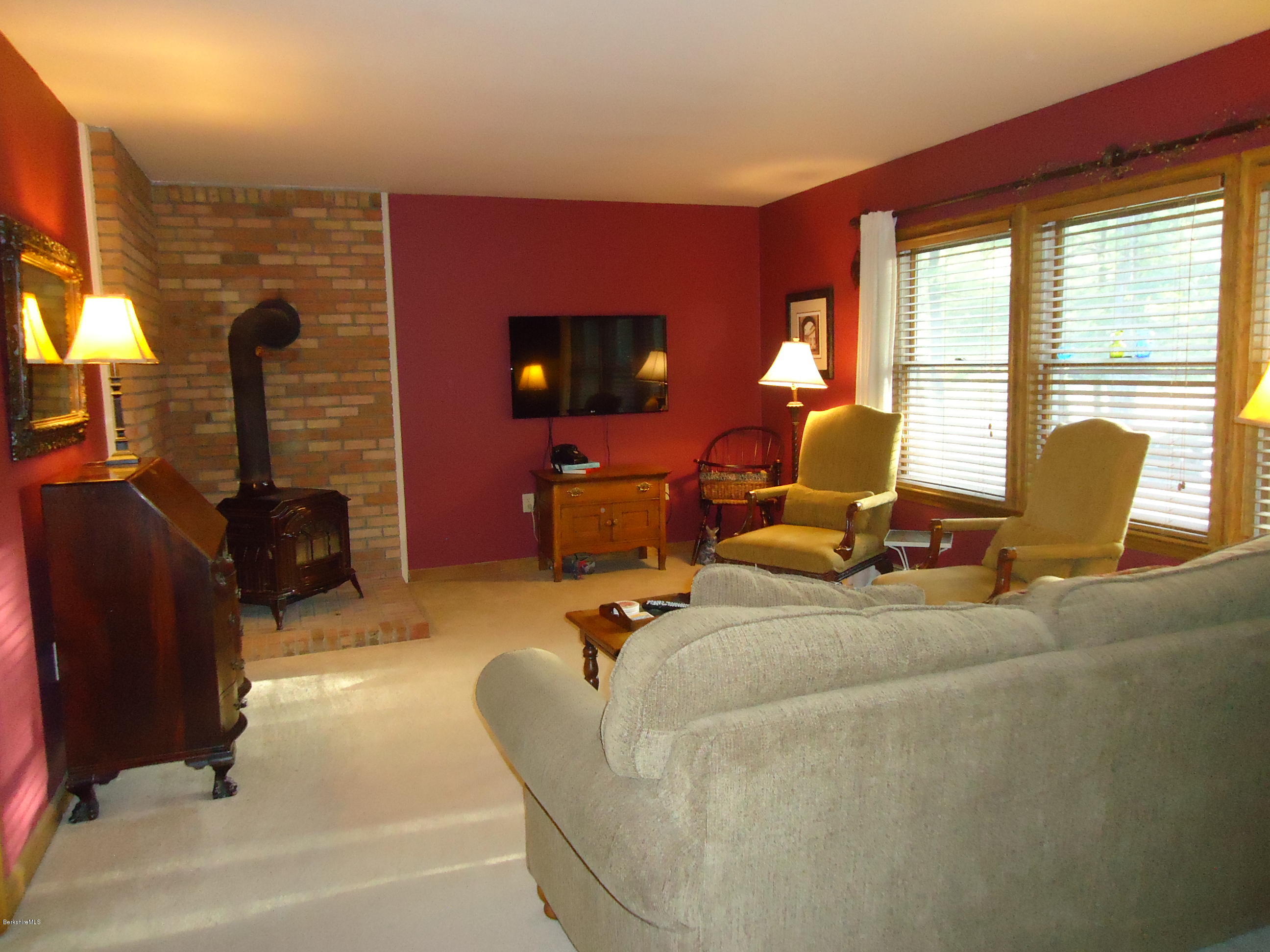 209 Polikoff Road Sheffield, MA 01222 - Photo 5 of 16 a living room with furniture fireplace and a large window