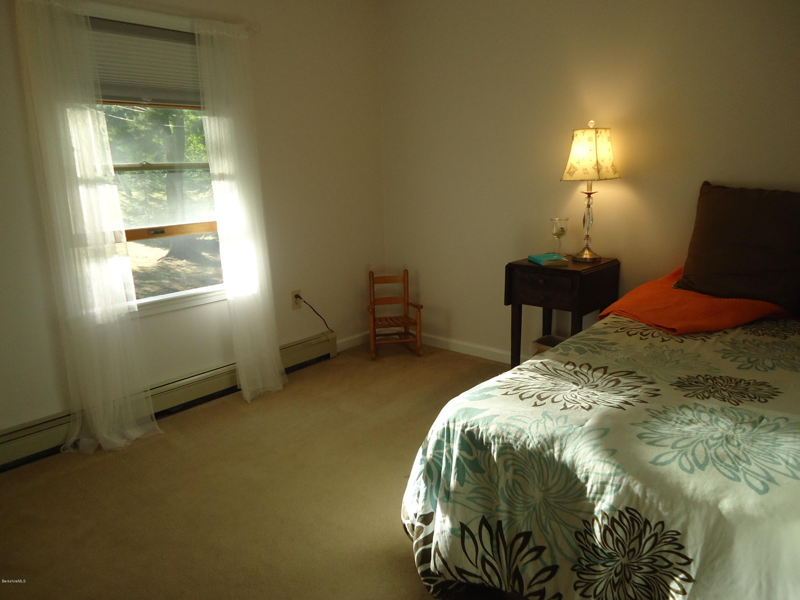 209 Polikoff Road Sheffield, MA 01222 - Photo 8 of 16 a bedroom with a bed and a window