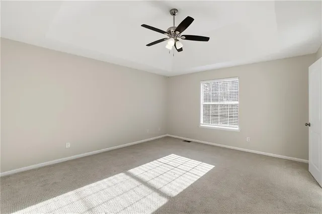 a view of wooden floor and a chandelier fan in a room