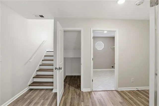 a view of a hallway with wooden floor and entryway