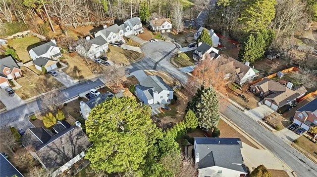 an aerial view of residential houses with outdoor space