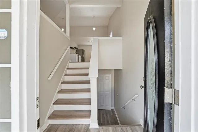 a view of entryway with wooden floor and white walls
