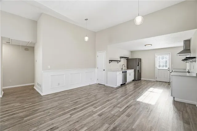 a view of a kitchen with furniture and wooden floor