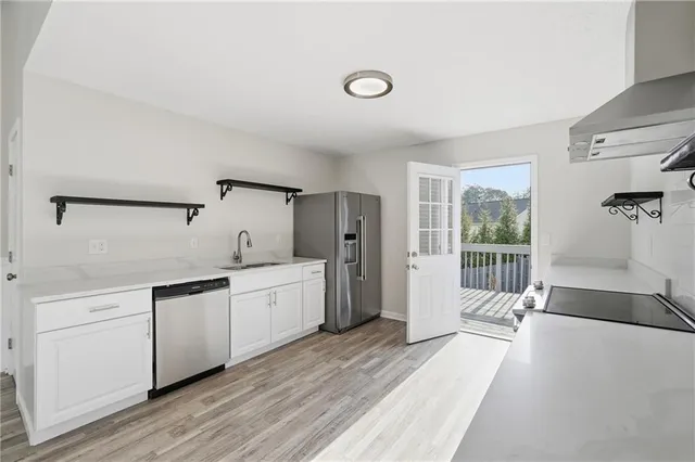 a large room with a large window and stainless steel appliances