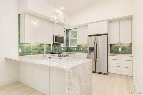a view of a room with a sink and cabinets