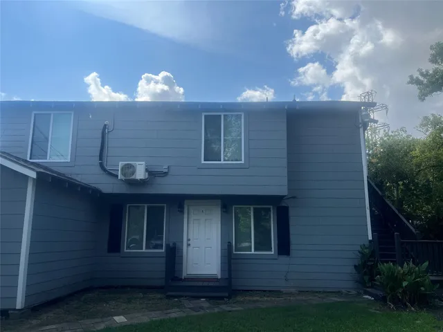 a view of a house with a yard next to a yard