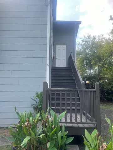 a view of a backyard with chairs potted plants