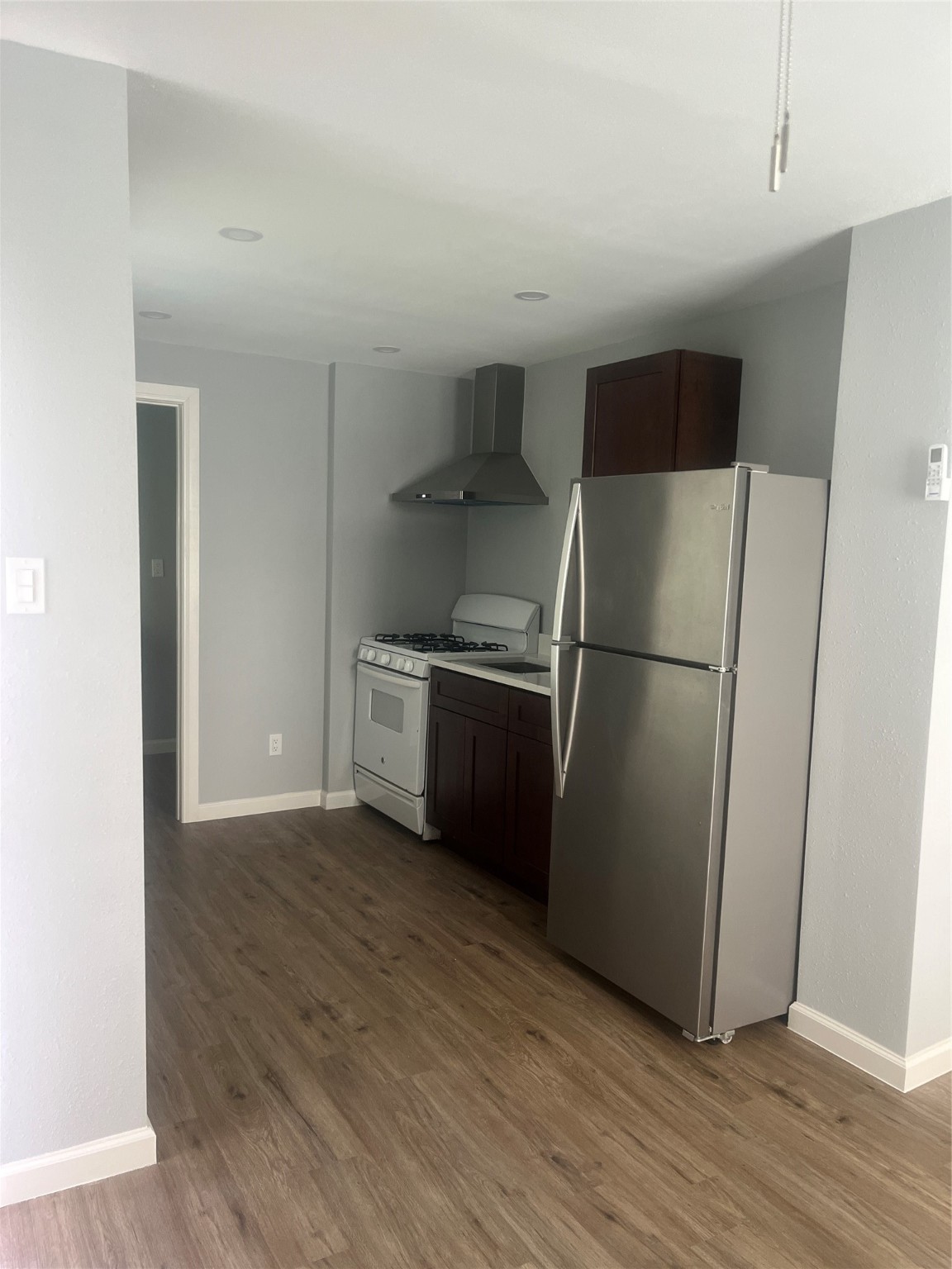 5404 Pease Street, Unit 3 Houston, TX 77023 - Photo 5 of 9 a kitchen with a refrigerator sink and wooden floor