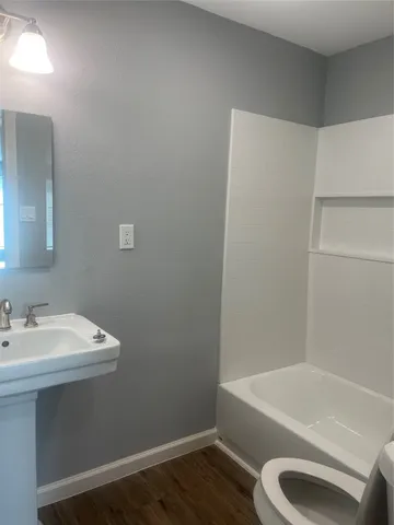 a bathroom with a sink a toilet and bathtub