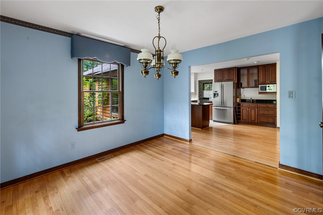 1600 Beaverdam Creek Road Crozier, VA 23039 - Photo 19 of 45 a view of a kitchen with a stove wooden cabinet wooden floor chandelier and windows