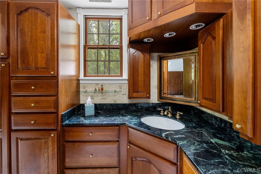 1600 Beaverdam Creek Road Crozier, VA 23039 - Photo 28 of 45 a bathroom with a granite countertop sink and a large mirror