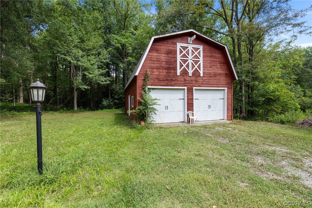 1600 Beaverdam Creek Road Crozier, VA 23039 - Photo 41 of 45 a view of a barn house with a big yard and large trees