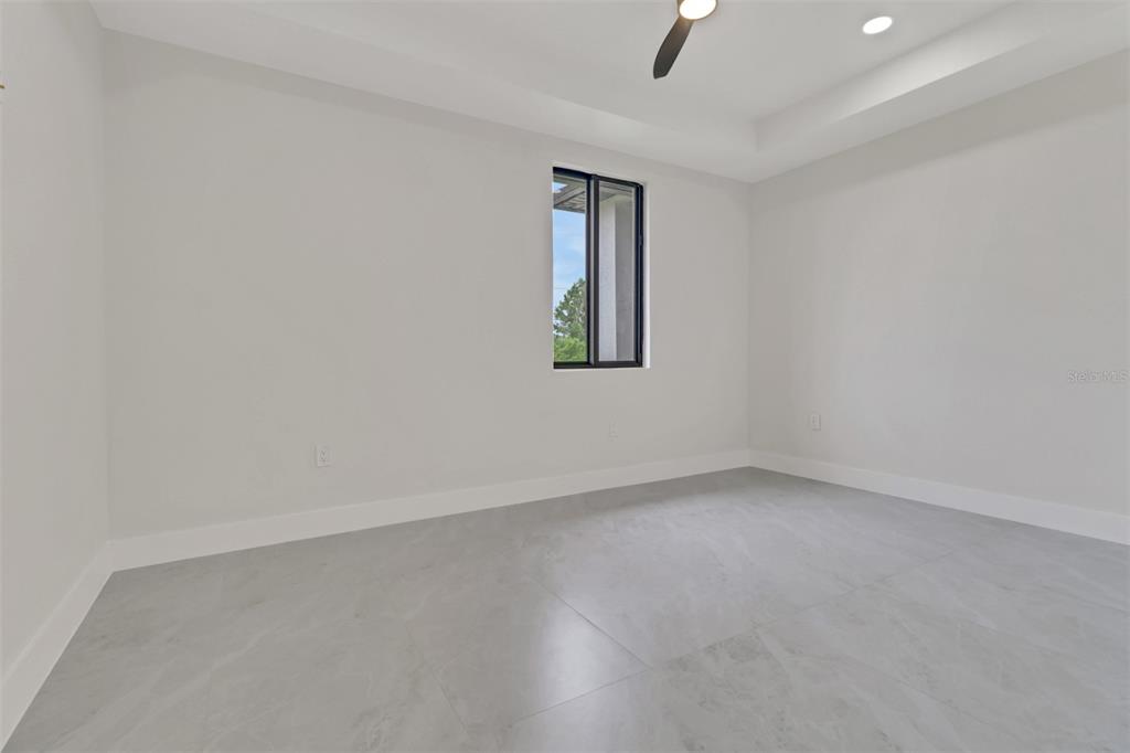 4501 15th Street Southwest Lehigh Acres, FL 33973 - Photo 20 of 40 an empty room with a window and ceiling fan