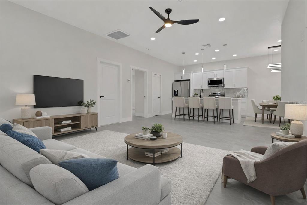 4501 15th Street Southwest Lehigh Acres, FL 33973 - Photo 24 of 40 a living room with furniture and a flat screen tv