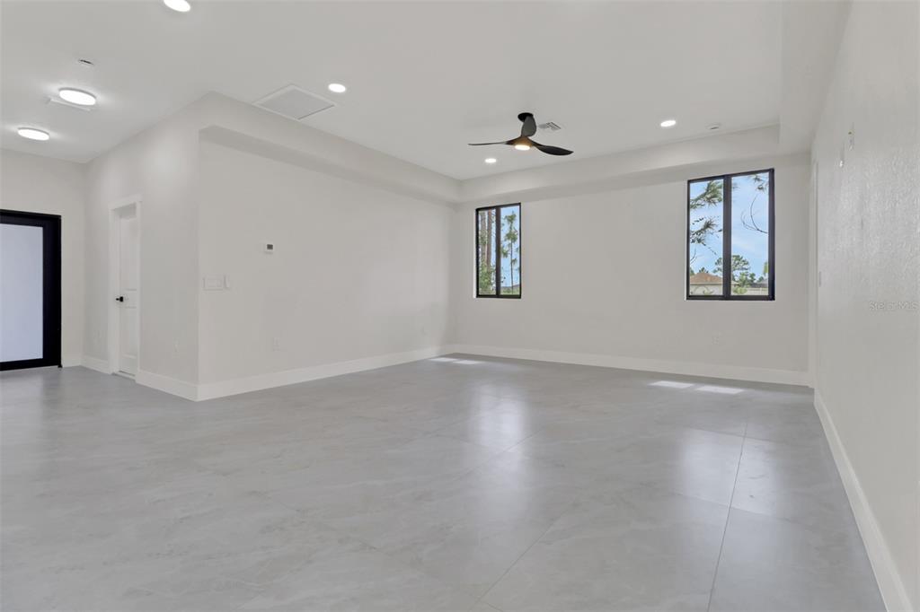 4501 15th Street Southwest Lehigh Acres, FL 33973 - Photo 25 of 40 an empty room with wooden floor and windows