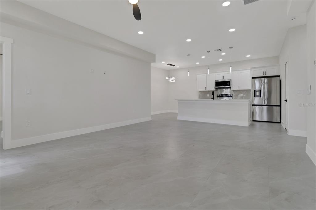 4501 15th Street Southwest Lehigh Acres, FL 33973 - Photo 27 of 40 a view of a kitchen with refrigerator and a stove