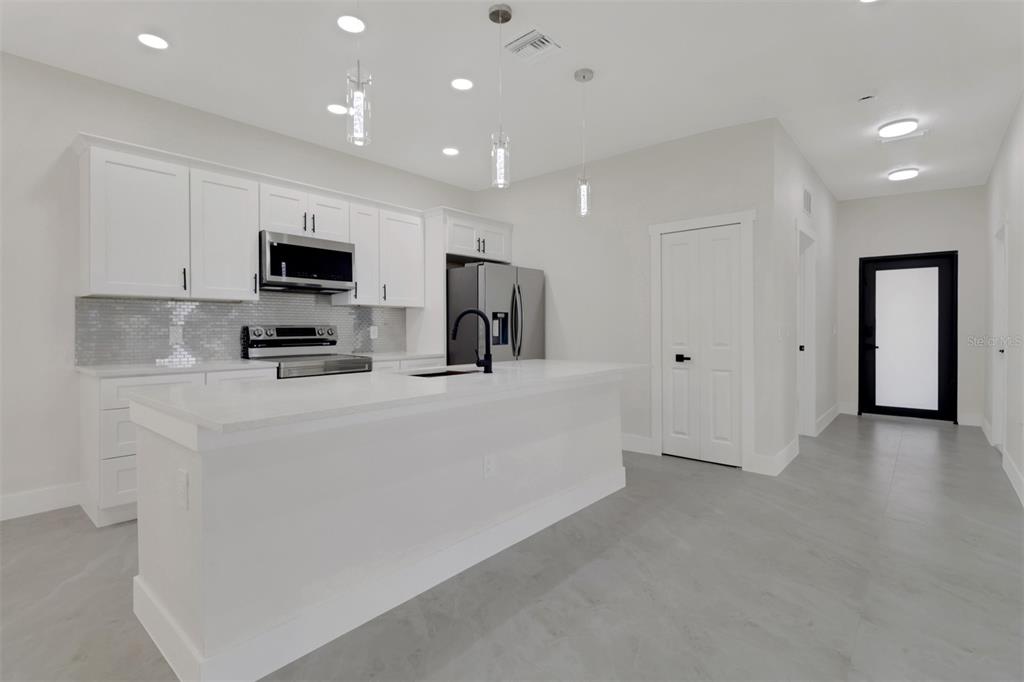 4501 15th Street Southwest Lehigh Acres, FL 33973 - Photo 28 of 40 a view of kitchen with stainless steel appliances cabinets and a refrigerator
